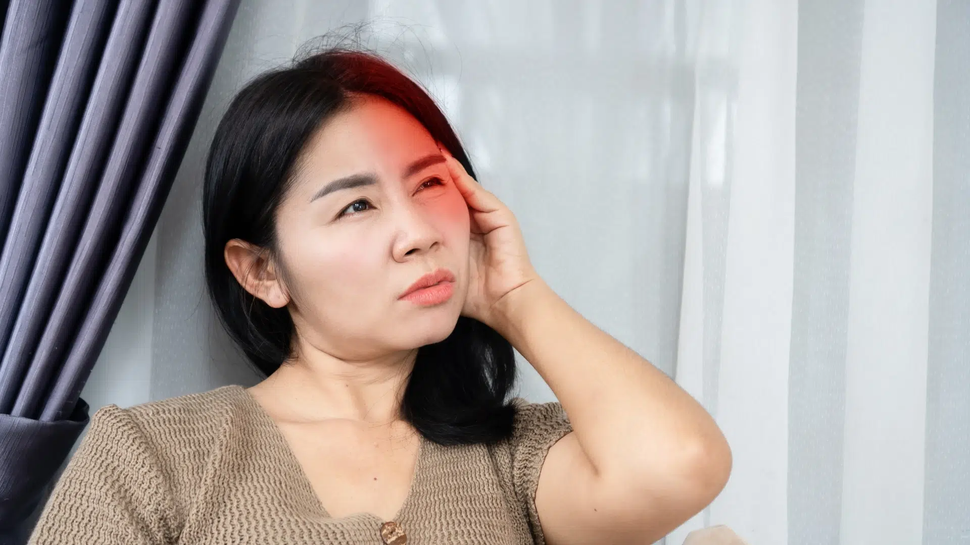 woman having migraine symptoms exploring solutions with Tailored Health AI personalized health assessment plans